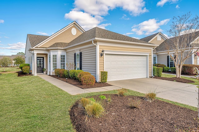 view of front of home featuring a garage, concrete driveway, a front yard, and roof with shingles