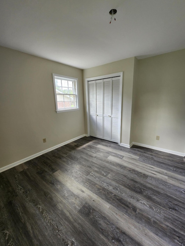 unfurnished bedroom featuring a closet and wood-type flooring