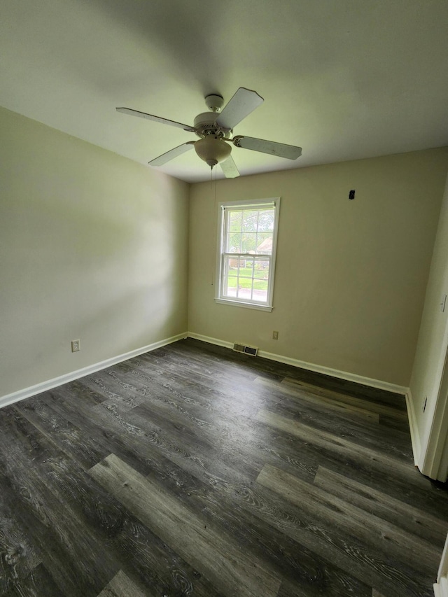 unfurnished room with dark hardwood / wood-style flooring and ceiling fan