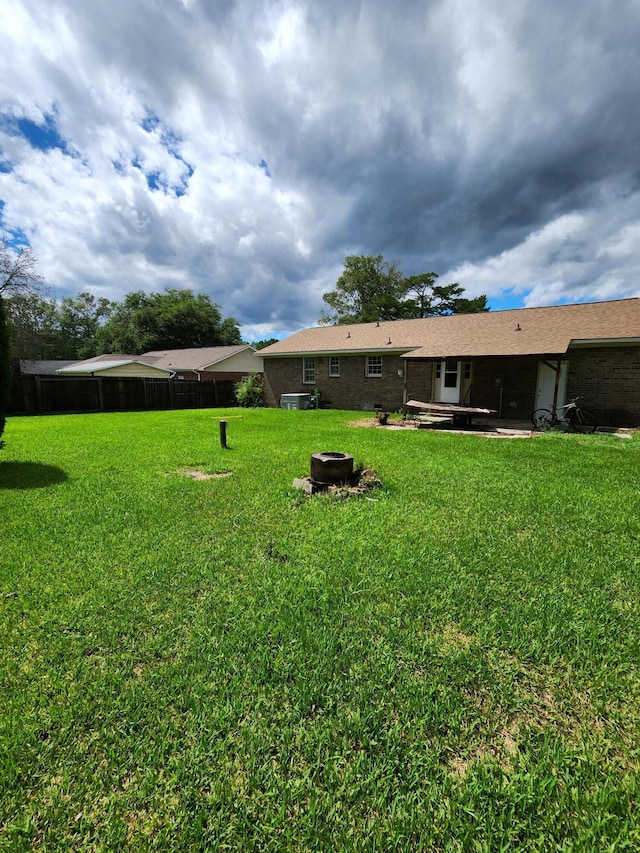 view of yard featuring a patio area and an outdoor fire pit