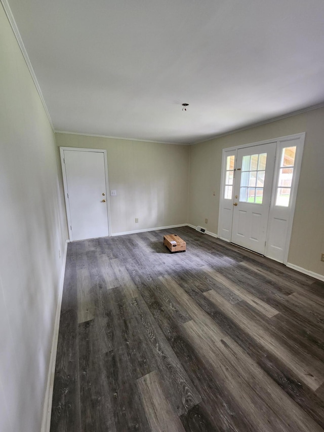 empty room featuring hardwood / wood-style flooring and ornamental molding