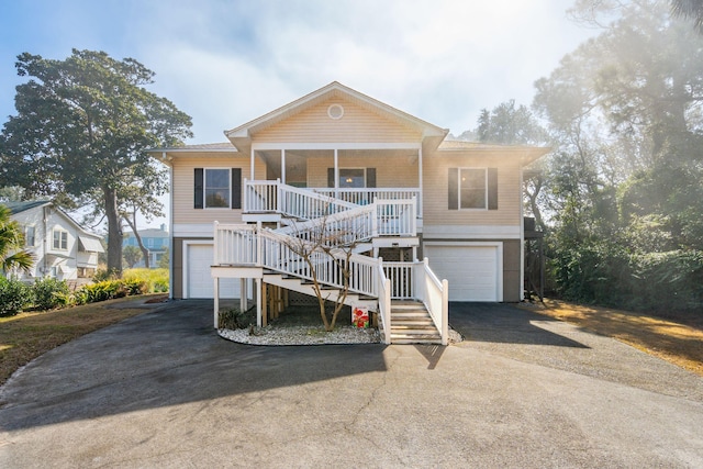 coastal home featuring a garage and covered porch