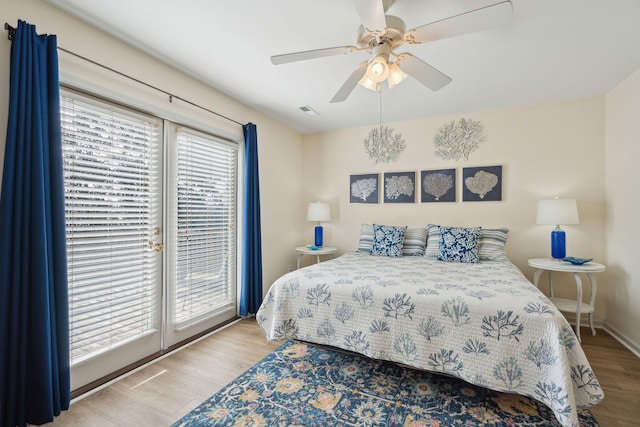 bedroom with light hardwood / wood-style flooring, access to outside, and ceiling fan