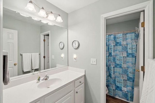 full bathroom featuring vanity, shower / bathtub combination with curtain, and toilet