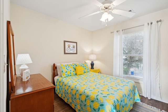 bedroom with dark hardwood / wood-style floors and ceiling fan