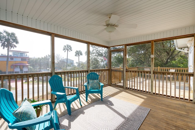 sunroom / solarium featuring ceiling fan