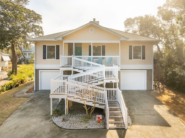 view of front of house featuring a porch and a garage