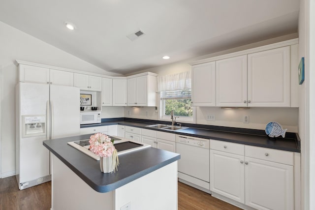 kitchen featuring sink, white appliances, white cabinetry, a center island, and vaulted ceiling