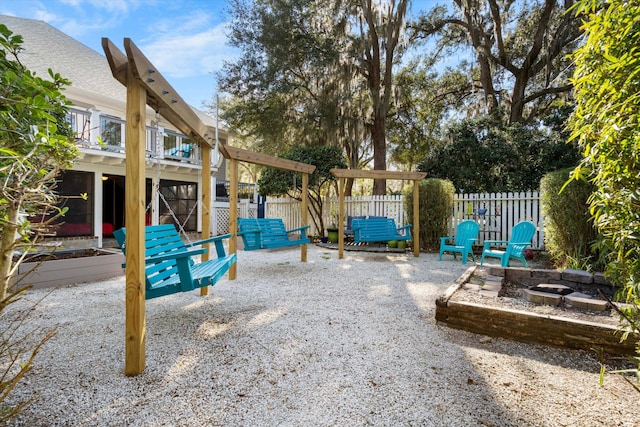 view of jungle gym with an outdoor fire pit, a patio, and fence