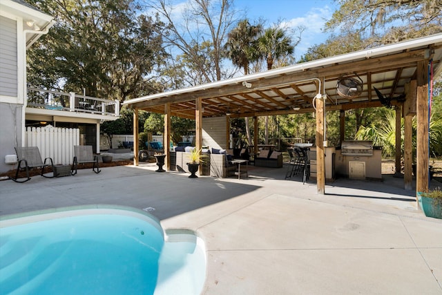 pool featuring a patio area, area for grilling, an outdoor kitchen, and an outdoor hangout area