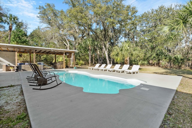 outdoor pool with a patio area and outdoor lounge area