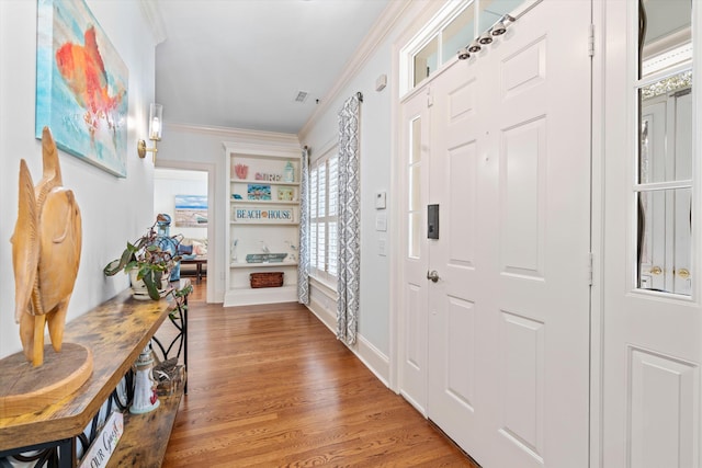 interior space featuring light wood-type flooring and crown molding