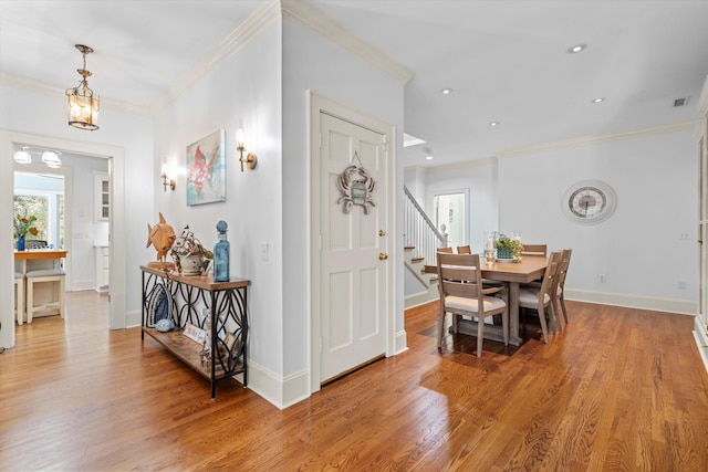 interior space with light wood-style floors, baseboards, and crown molding