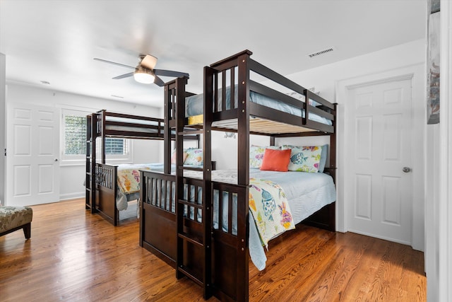 bedroom featuring visible vents and wood finished floors