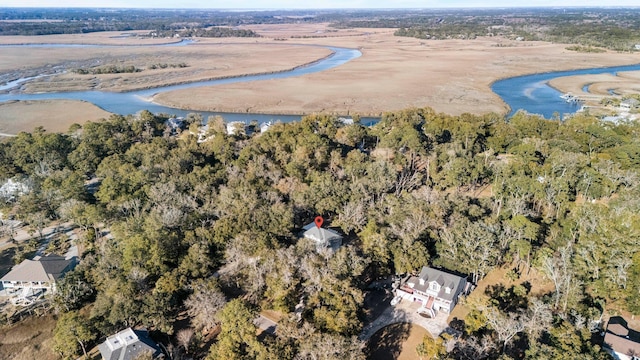 birds eye view of property with a water view and a wooded view