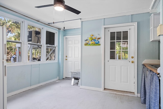 unfurnished sunroom with a wealth of natural light and ceiling fan