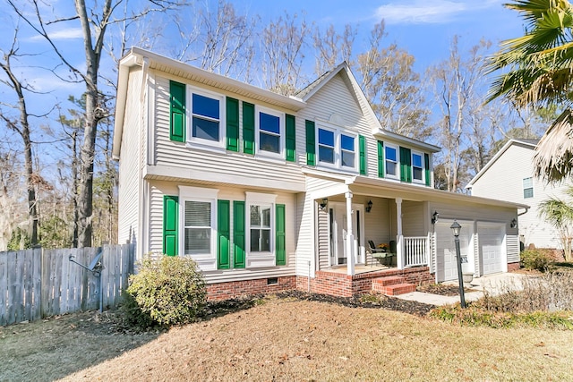 view of front facade with a garage and covered porch