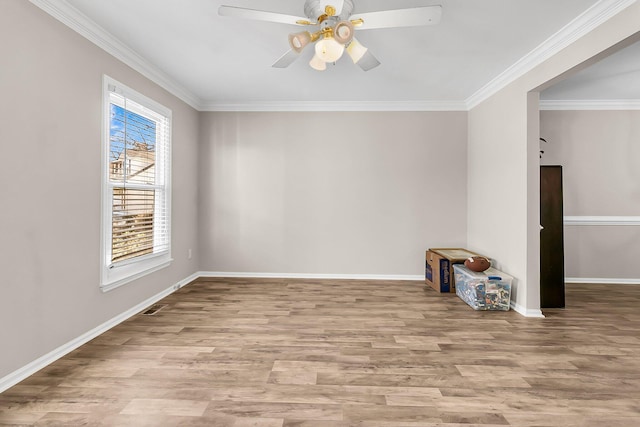 spare room featuring ceiling fan, ornamental molding, and light hardwood / wood-style floors