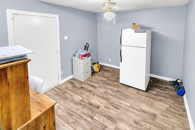 kitchen with light wood-type flooring and white fridge