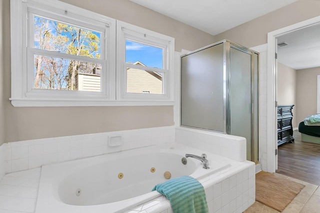 bathroom featuring tile patterned floors and separate shower and tub