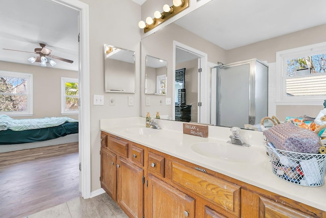 bathroom with vanity, an enclosed shower, and ceiling fan