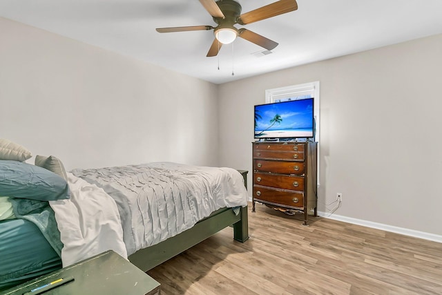 bedroom with light hardwood / wood-style floors and ceiling fan