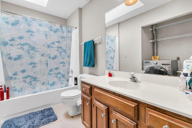 full bathroom with toilet, washer / dryer, a skylight, vanity, and tile patterned flooring