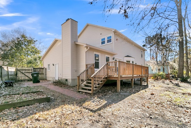 rear view of property featuring a wooden deck