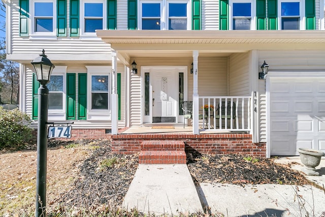 entrance to property with a garage and a porch