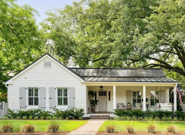 509 Klein St, Mount Pleasant, SC 29464 - view of front of home with a standing seam roof, a porch, and a metal roof