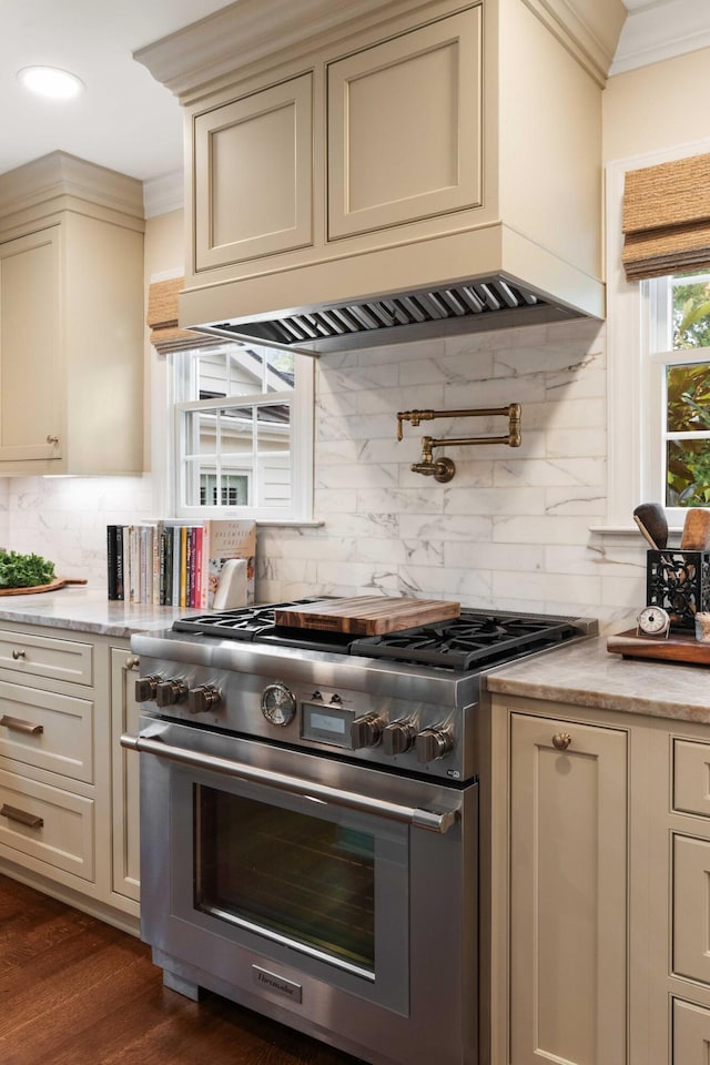 509 Klein St, Mount Pleasant, SC 29464 - kitchen featuring high end range, ornamental molding, cream cabinetry, decorative backsplash, and custom range hood