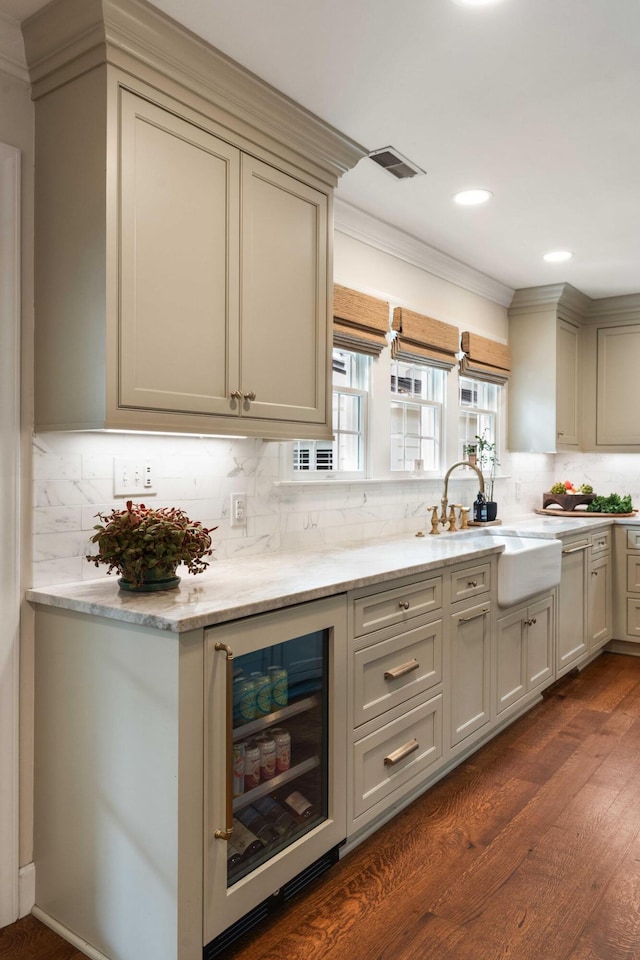 509 Klein St, Mount Pleasant, SC 29464 - kitchen with beverage cooler, ornamental molding, dark wood-style floors, decorative backsplash, and light stone counters