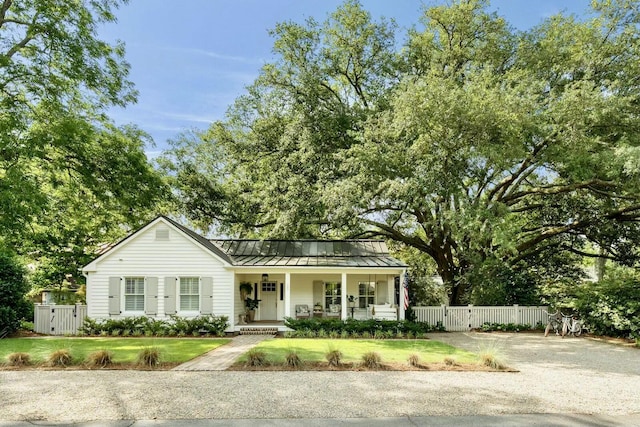 509 Klein St, Mount Pleasant, SC 29464 - view of front of house with a standing seam roof, covered porch, a gate, and a metal roof