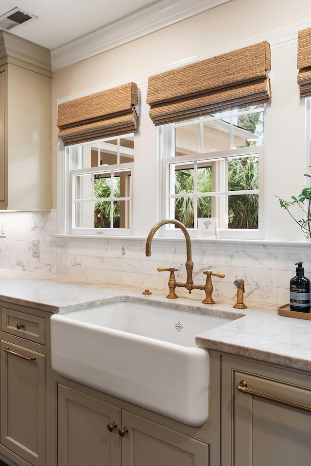 509 Klein St, Mount Pleasant, SC 29464 - kitchen with gray cabinets, ornamental molding, backsplash, and light stone countertops