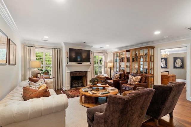 509 Klein St, Mount Pleasant, SC 29464 - living area with crown molding, wood finished floors, a brick fireplace, a chandelier, and recessed lighting
