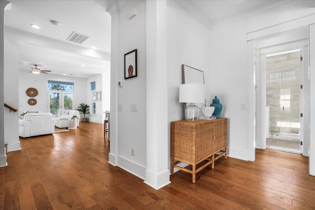 hall with dark hardwood / wood-style floors and ornamental molding