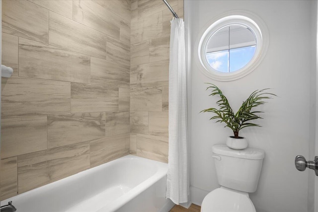 bathroom with toilet and shower / bath combo with shower curtain