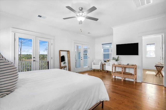 bedroom with ceiling fan, french doors, dark wood-type flooring, crown molding, and access to outside