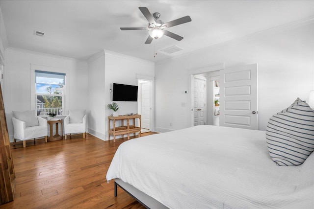 bedroom featuring ceiling fan, crown molding, and dark wood-type flooring