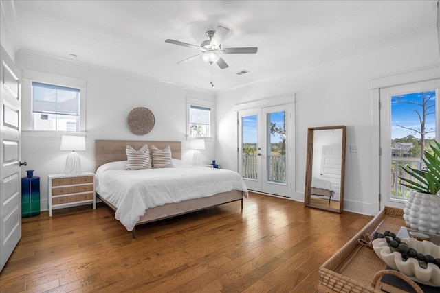 bedroom with ceiling fan, access to exterior, and multiple windows