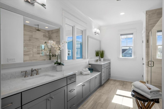 bathroom featuring crown molding, vanity, an enclosed shower, and hardwood / wood-style flooring