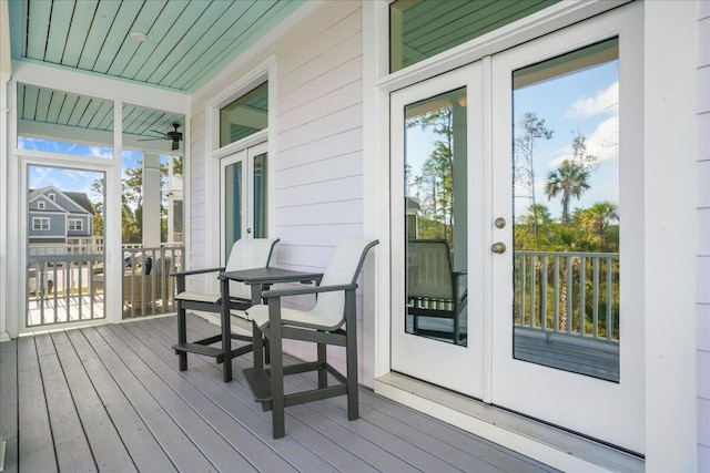 deck with french doors and a ceiling fan
