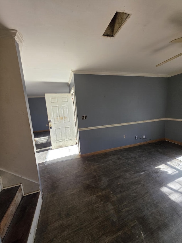 empty room featuring ornamental molding, ceiling fan, baseboards, and wood finished floors