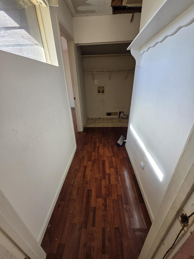 hallway featuring wood finished floors and baseboards