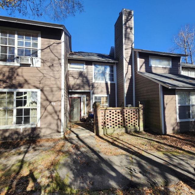 back of property with a chimney