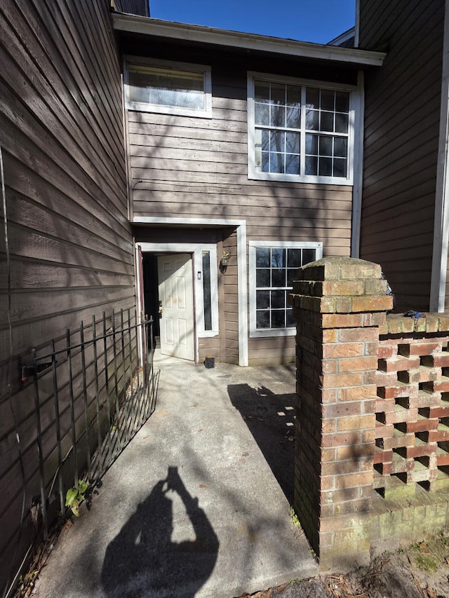 entrance to property featuring fence