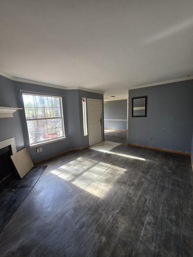 unfurnished living room with ornamental molding, a fireplace, wood finished floors, and baseboards