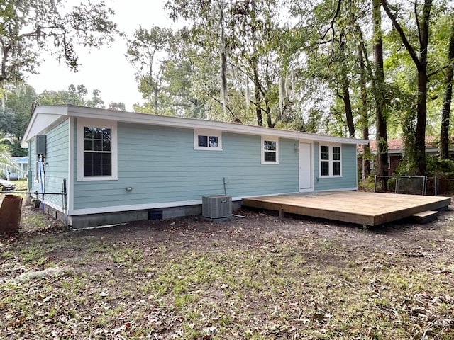 rear view of house featuring central AC and a deck