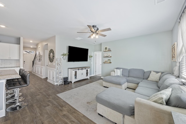 living room with ceiling fan, dark wood finished floors, and recessed lighting