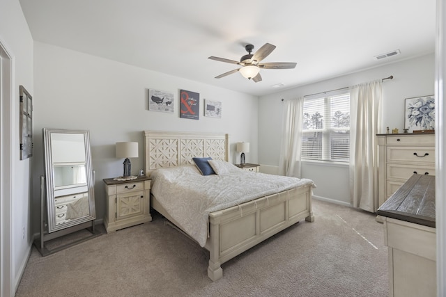 bedroom with ceiling fan, visible vents, baseboards, and light colored carpet